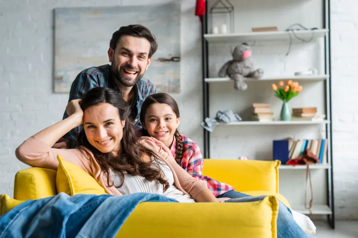 Happy family on yellow couch