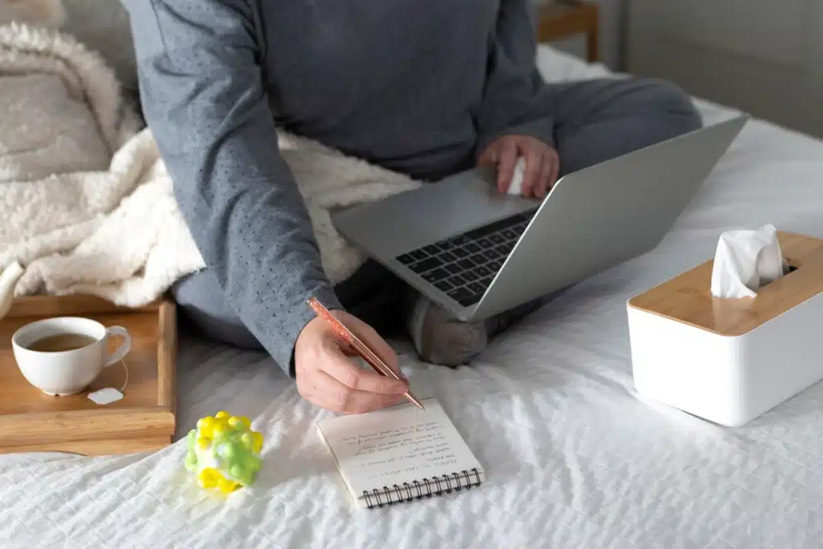 Person working on laptop in bed