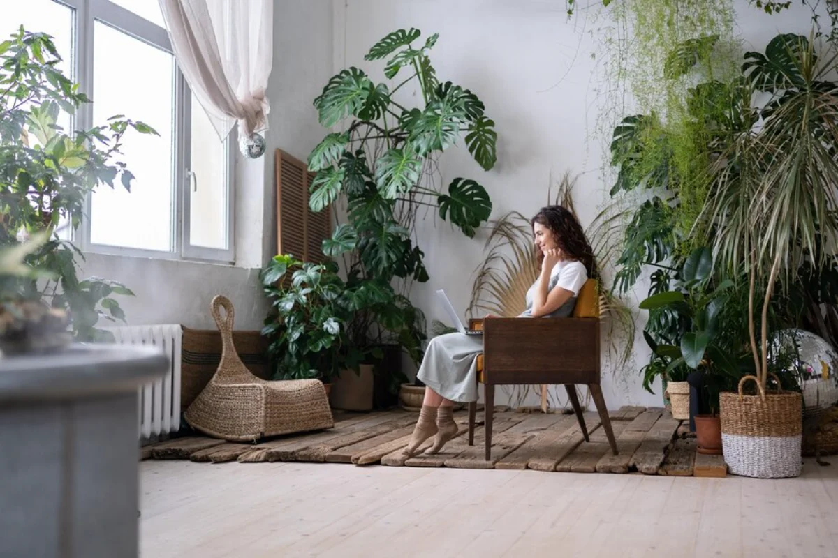 Woman working in plant-filled room
